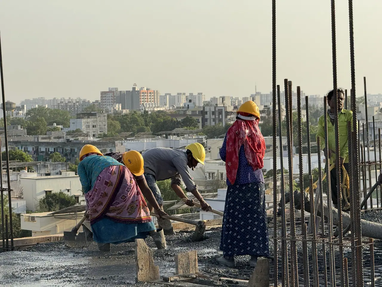 Site team preparing a slab around column reinforcement at Shreeji Avenue