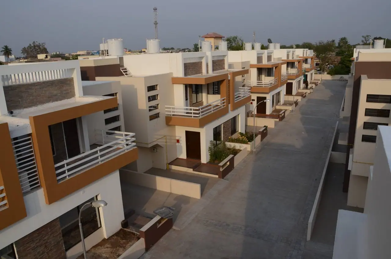 Shreeji Darshan row of duplex bungalows with orange-trimmed balconies