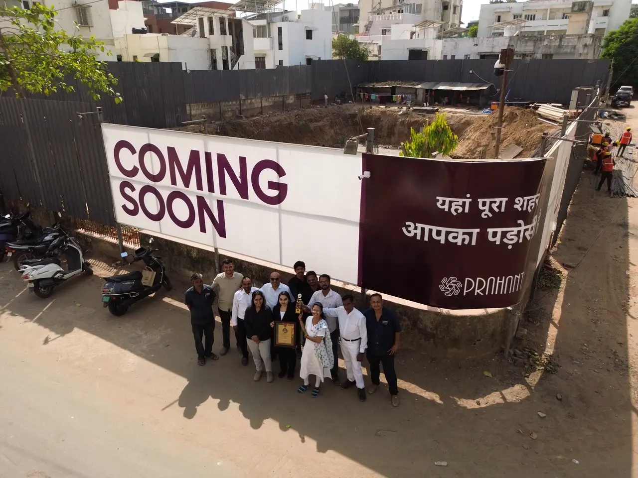 The Prahant team in front of the Shreeji Elora coming-soon hoarding