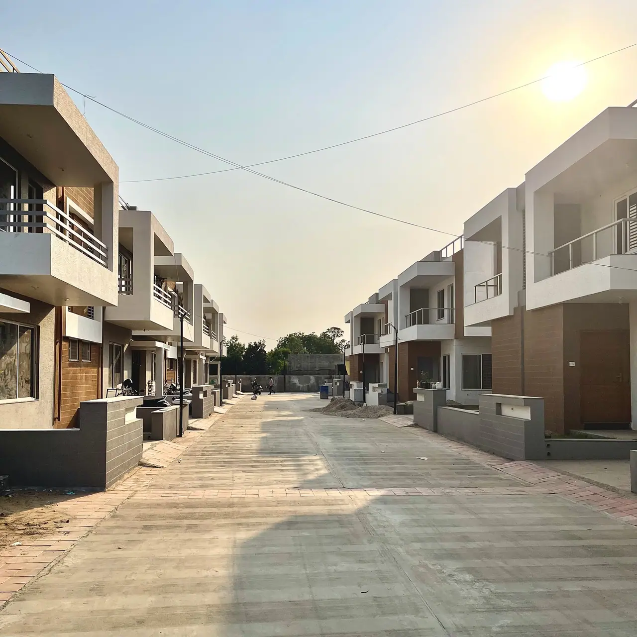 Finished row houses along the internal road at Shreeji Vandan