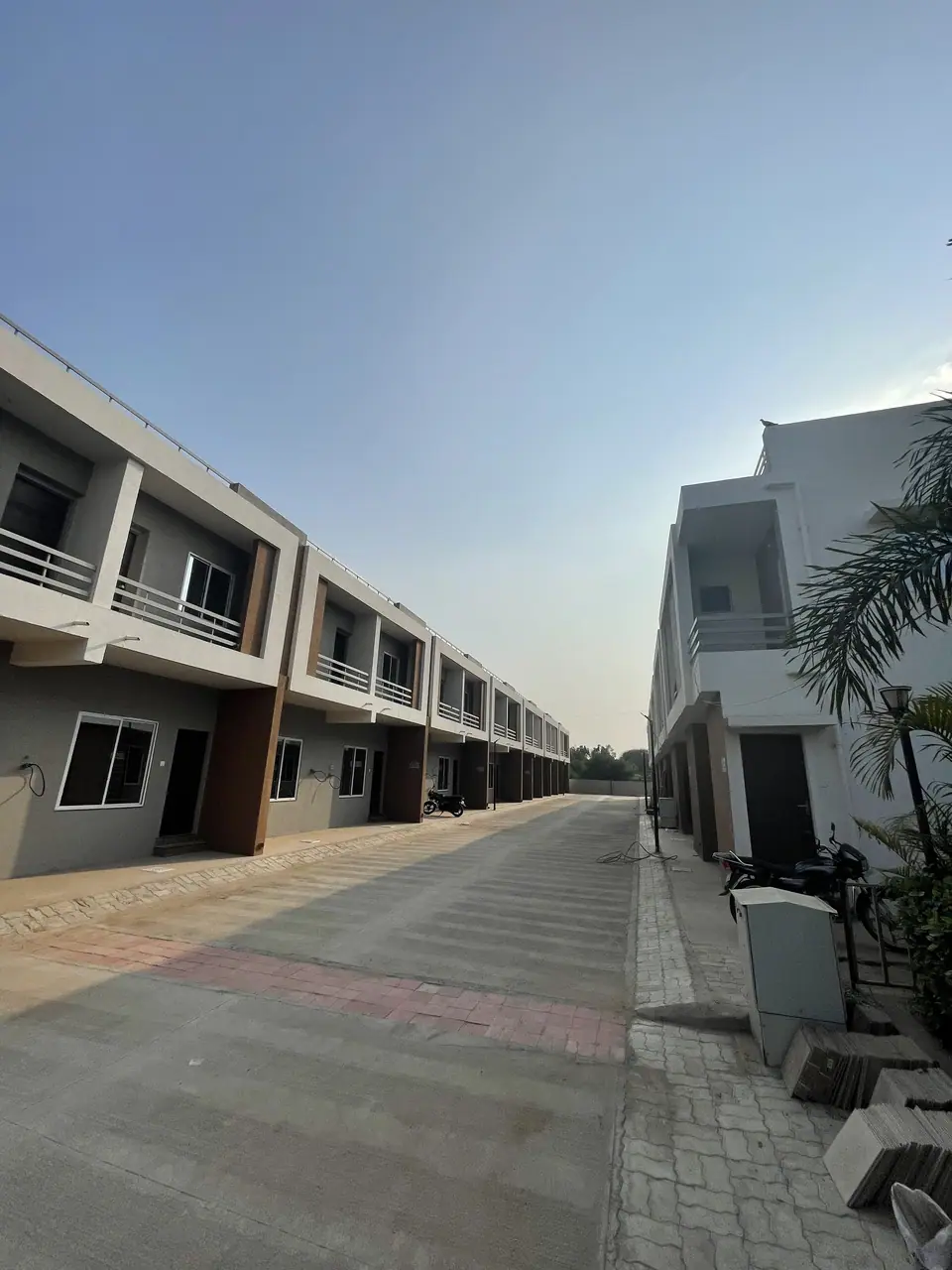 Paved internal road between rows of houses at Shreeji Vandan