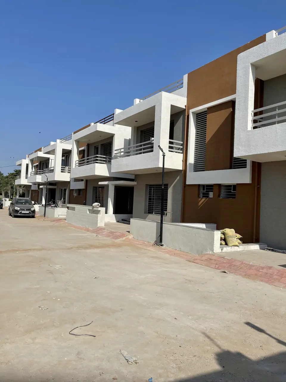 Completed Shreeji Vandan homes with paved forecourts